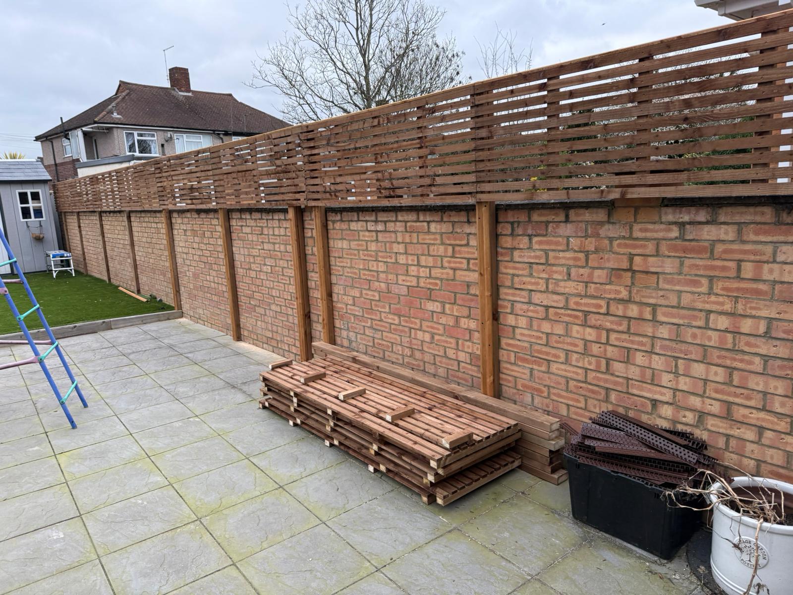 Brick wall boundary with trellis fencing panels completed by FenceGuard London